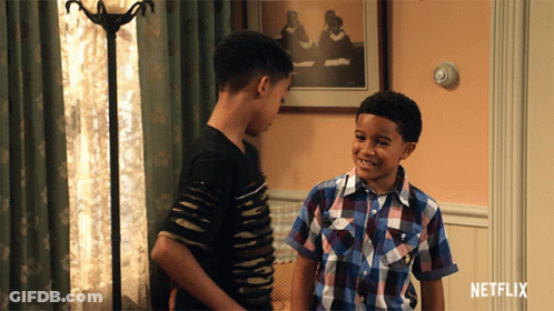 Two Boys Standing In Living Room With Netflix Logo GIF