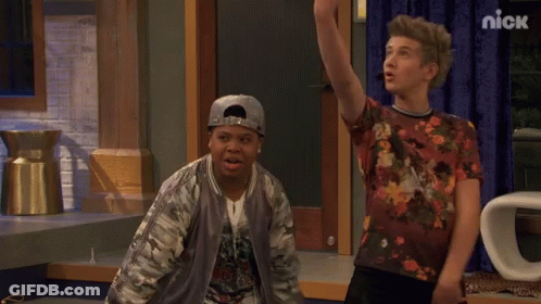 Two Boys Standing Next To Nick Sign GIF