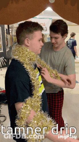 Two Boys Wearing Tinsel With Tamner Drip GIF