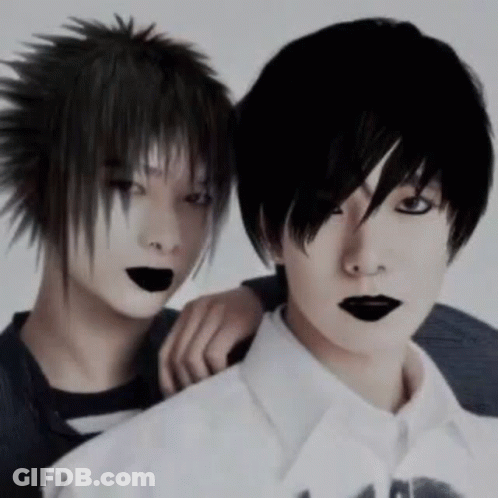 Two Boys With Black Hair And Black Lips Are Posing For A Picture . GIF