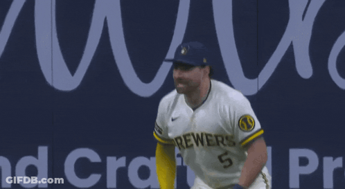 Two Brewers Baseball Players Standing In Front Of Banner GIF