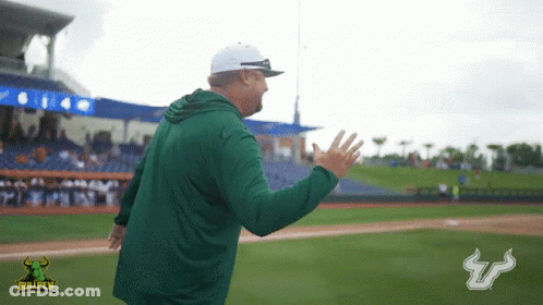 Two Bullpen Football Players Shake Hands In Front Of Raymond James Stadium Billboard GIF