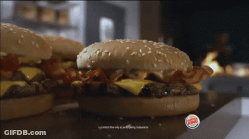 Two Burger King Hamburgers Are Sitting On A Counter GIF