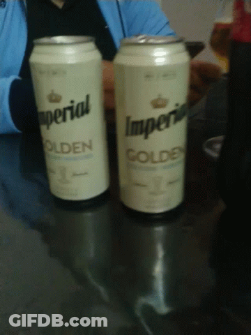 Two Cans Of Imperial Golden Sit On A Table GIF