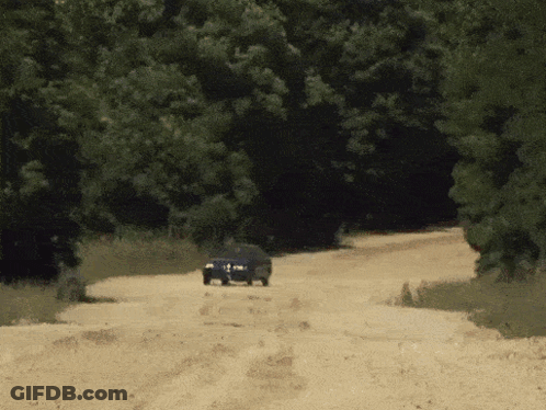 Two Cars Driving Down Dirt Road GIF