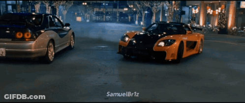 Two Cars Driving Down Street GIF