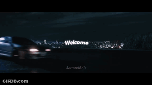 Two Cars Driving Past Welcome Sign GIF