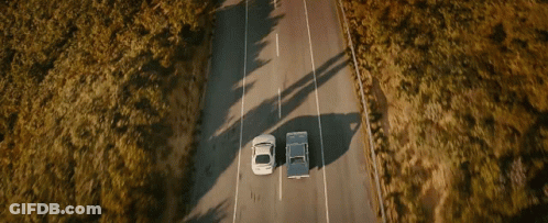 Two Cars Driving With Arrow Pointing Right GIF