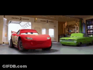 Two Cars From The Movie Cars Are Standing Next To Each Other In A Paint Booth . GIF