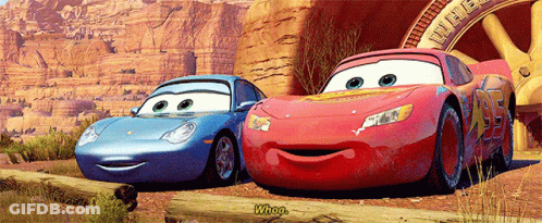 Two Cars From The Movie Cars Are Standing Next To Each Other GIF