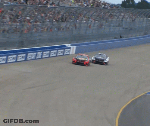 Two Cars Racing On Track With Coca Cola Sign GIF