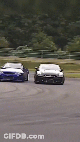 Two Cars Racing With Nissan Sticker GIF