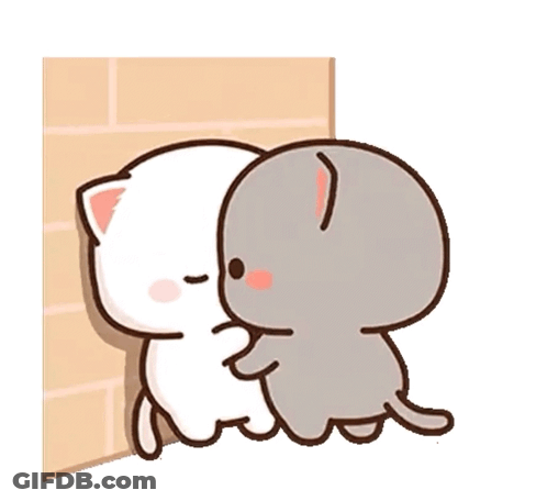 Two Cartoon Cats Are Hugging Each Other On A Brick Wall . GIF