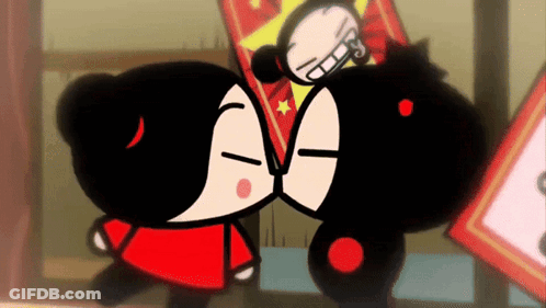 Two Cartoon Characters Are Kissing Each Other In Front Of A Sign . GIF