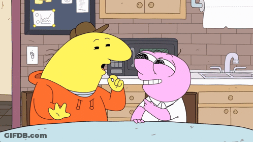 Two Cartoon Characters Are Sitting At A Table And One Has The Letter J On His Hoodie GIF