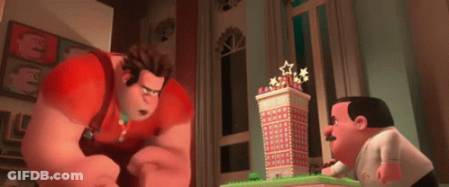 Two Cartoon Characters Are Standing Next To A Gingerbread Building . GIF