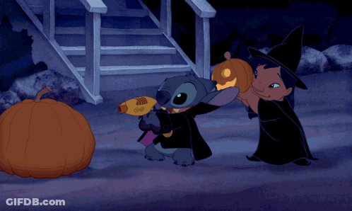 Two Cartoon Characters Beside Glowing Pumpkin GIF