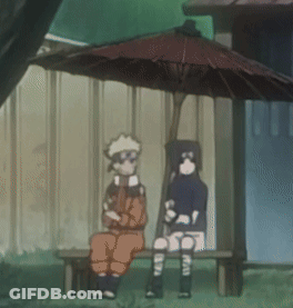 Two Cartoon Characters Sit Under An Umbrella In Front Of A Building GIF
