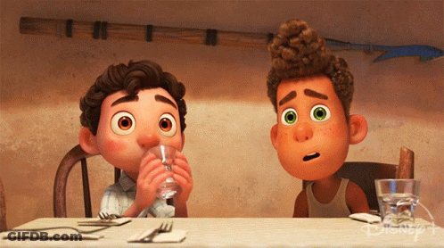 Two Cartoon Characters Sitting At Table With Disney Logo GIF