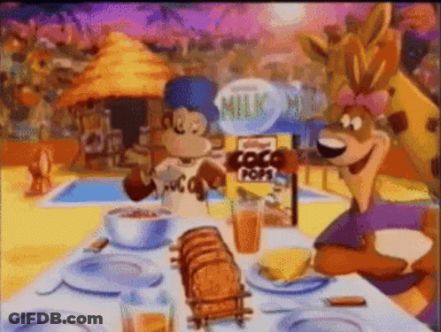Two Cartoon Characters Sitting At Table With Kellogg's Coco Pops GIF