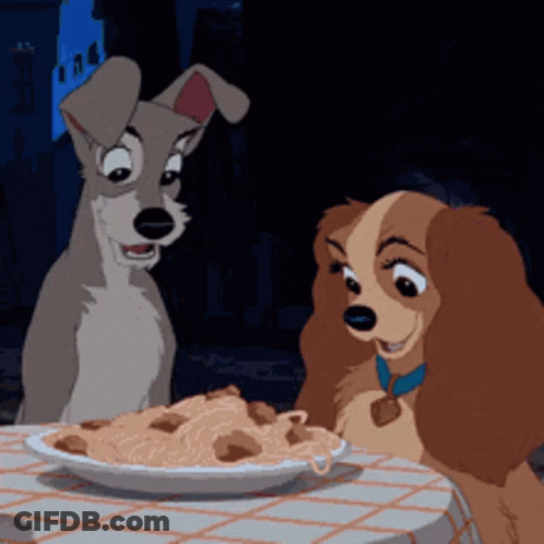 Two Cartoon Dogs Are Sitting At A Table With A Plate Of Spaghetti GIF