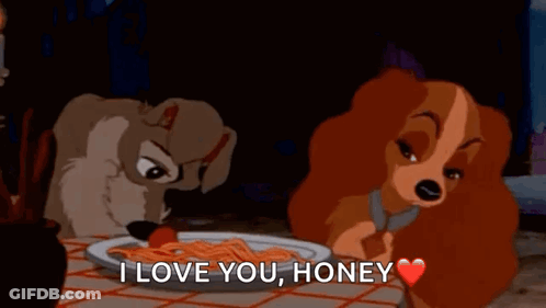Two Cartoon Dogs Sitting At Table With Spaghetti And Tomato GIF