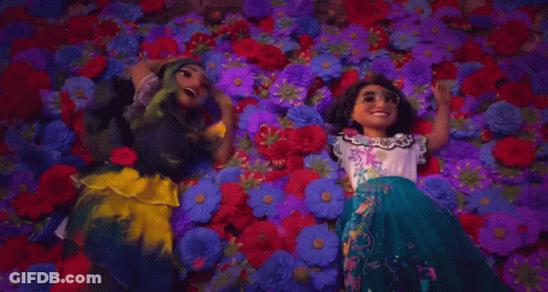 Two Cartoon Girls Laying In Pile Of Flowers GIF