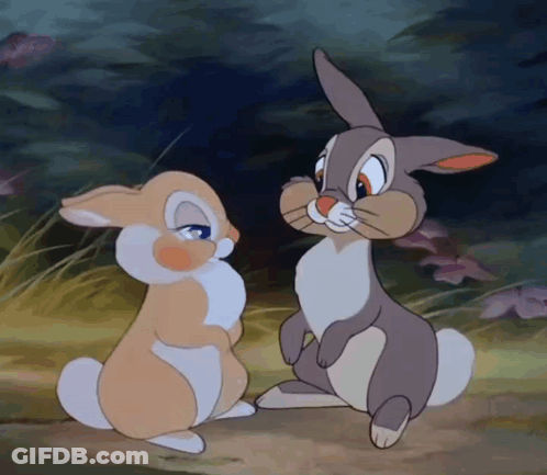 Two Cartoon Rabbits Are Looking At Each Other In A Field GIF