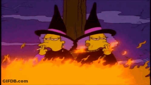 Two Cartoon Witches Smoking Cigarettes In Bonfire GIF