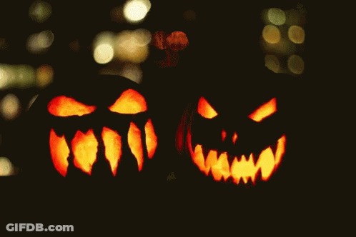 Two Carved Pumpkins With Glowing Faces GIF