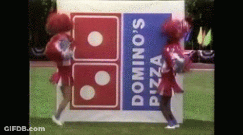 Two Cheerleaders Are Dancing In Front Of A Domino 'S Pizza Logo GIF