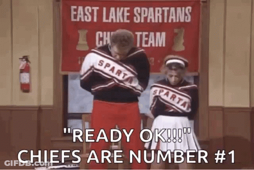 Two Cheerleaders In Front Of East Lake Spartans Cheer Team Sign GIF