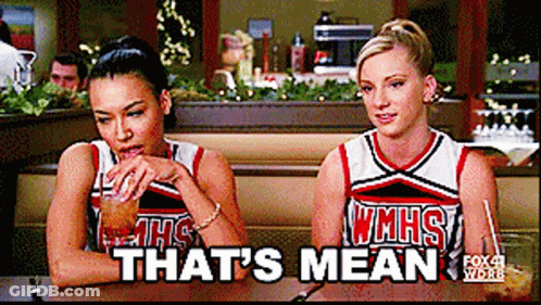 Two Cheerleaders Sitting At Table Saying That's Mean GIF