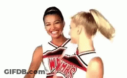 Two Cheerleaders Talking And Smiling GIF