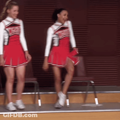 Two Cheerleaders Wearing Red Uniforms That Say Angels On Them GIF