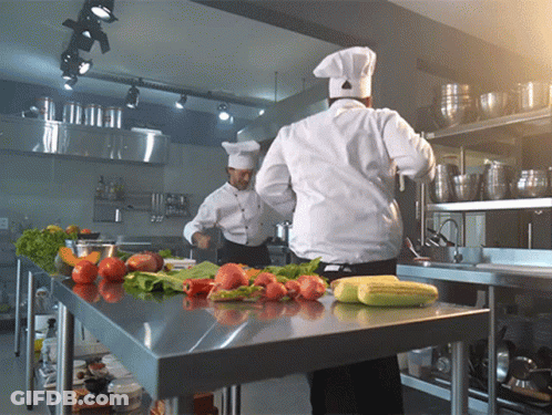 Two Chefs Cooking With Vegetables GIF