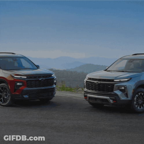 Two Chevrolet SUVs Parked On Mountain Road GIF