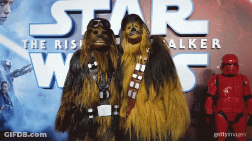 Two Chewbaccas In Front Of Star Wars Poster GIF