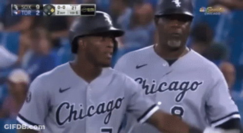 Two Chicago Baseball Players Are Talking To Each Other On The Field GIF