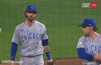 Two Chicago Cubs Baseball Players Are Talking To Each Other On The Field GIF