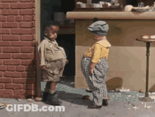 Two Children Standing In Front Of Brick Wall GIF