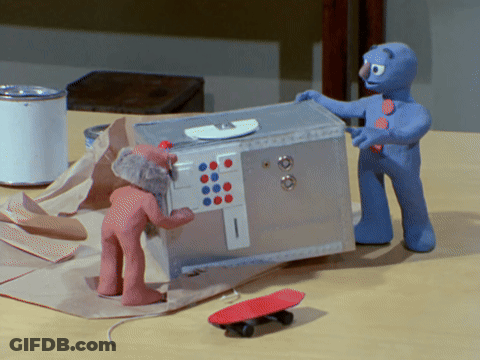 Two Clay Figures Beside Safe And Skateboard GIF