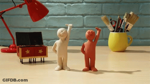 Two Clay Figures Standing Together GIF