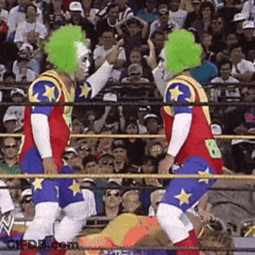 Two Clowns In A Wrestling Ring With The Number 8 On Their Backs GIF
