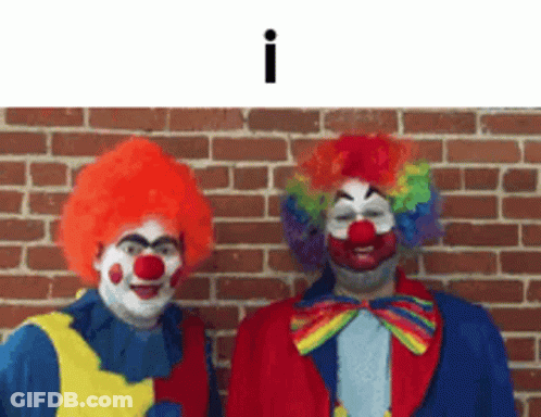 Two Clowns Standing Next To Brick Wall GIF