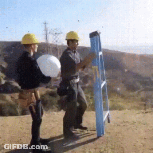 Two Construction Workers Standing Next To Ladder GIF