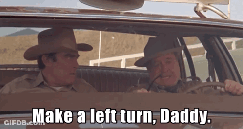 Two Cowboy Hat Men Saying Make Left Turn Driving GIF