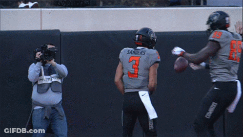 Two Cowboys Football Players Celebrate A Touchdown With A Referee GIF