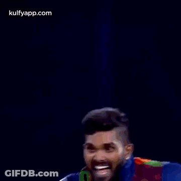 Two Cricket Players Are Standing Next To Each Other And Celebrating A Victory . GIF