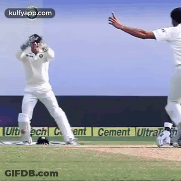 Two Cricket Players Playing On Cement Sponsored Field GIF